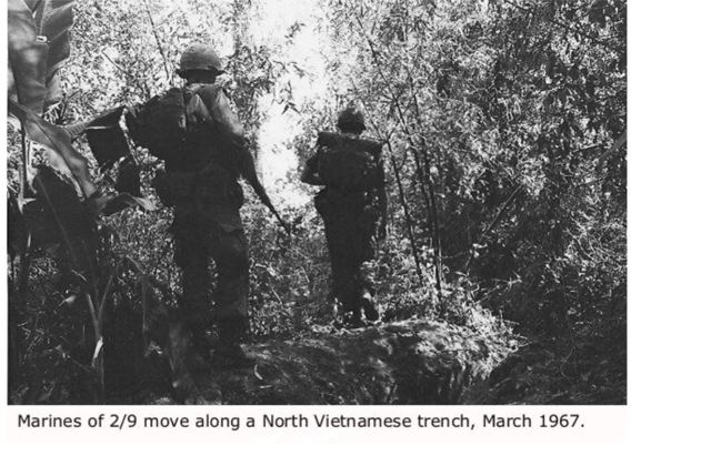 Marines of 2/9 move along a North Vietnamese trench, March 1967. U.S. Marine Corps photo
