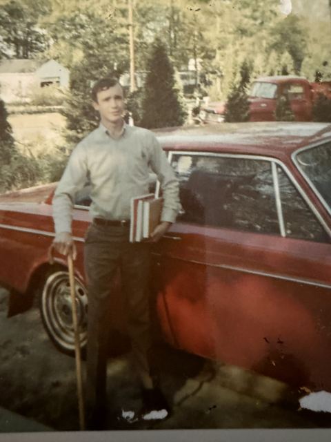 Russell home from Vietnam, with his cane and schoolbooks